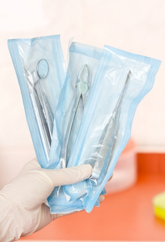 A dentist holding dental tools for consultation and surgical use packed in a protective foil that keeps them sterile for very long time-img-blog