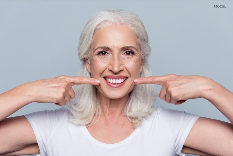 model with healthy straight white teeth at old age.